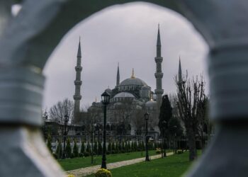 Sütunların arasından görünen kubbe ve minareleriyle tarihi cami.